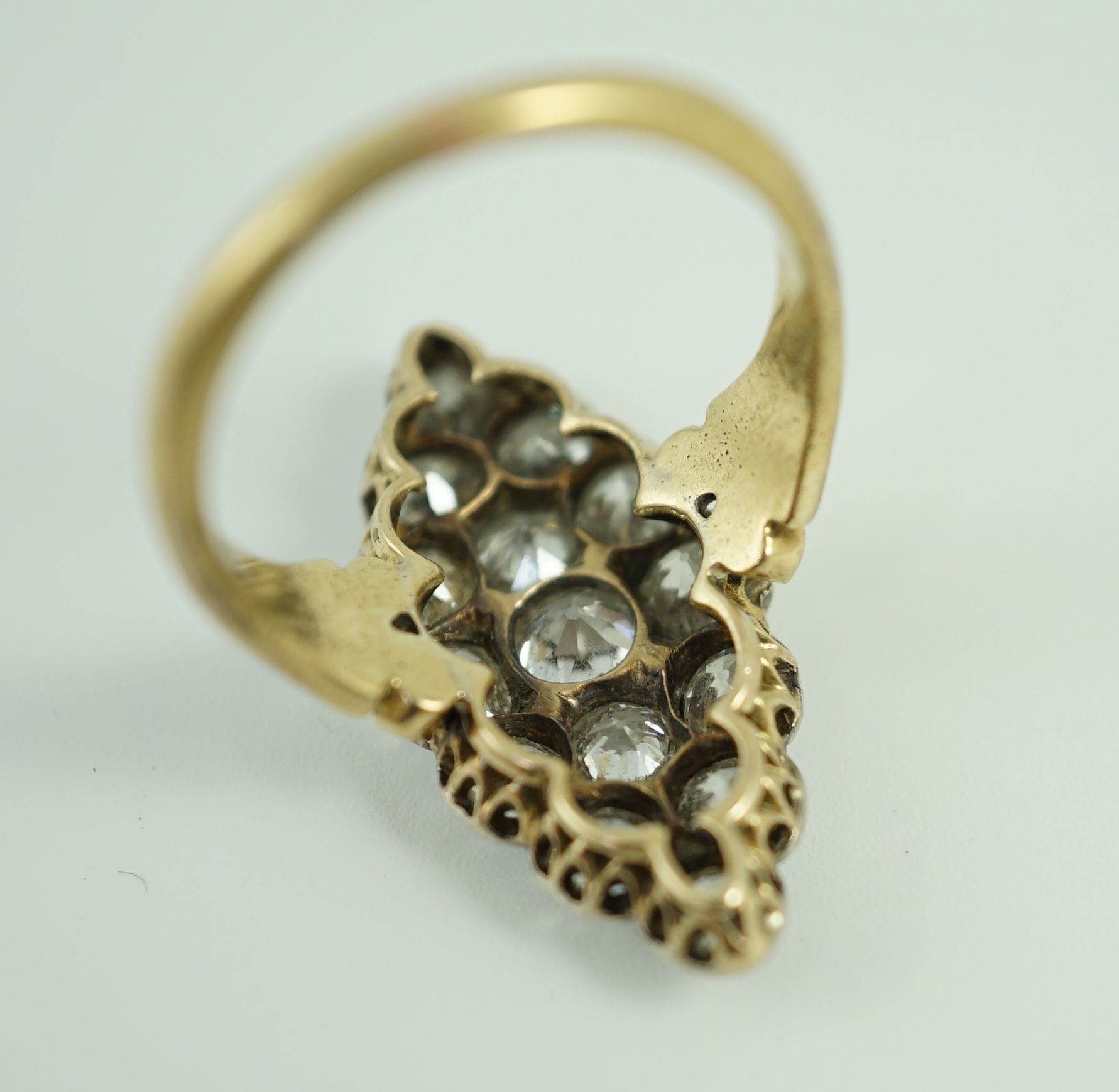 A Victorian style 18ct gold and fifteen stone diamond set marquise cluster dress ring